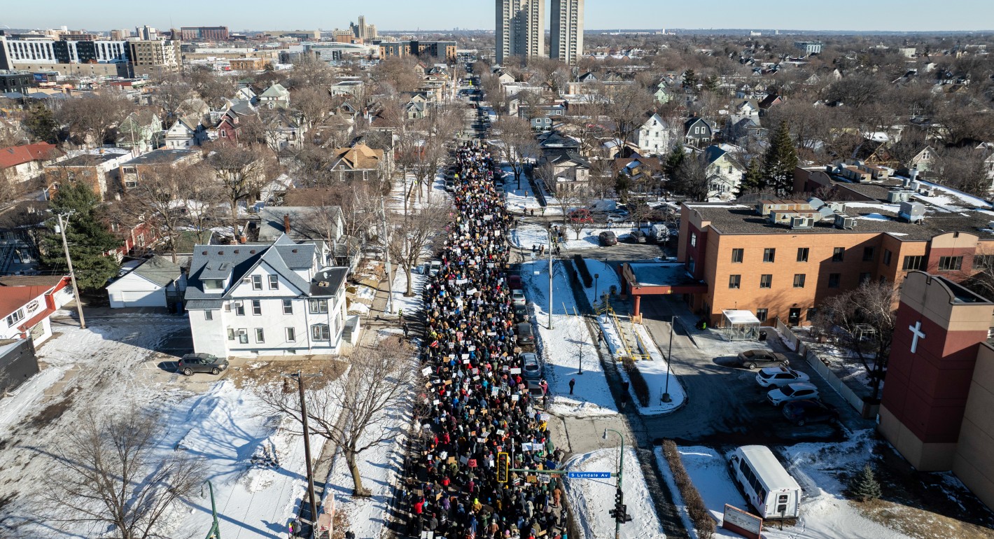 Aerial shot of protesters marching down a street