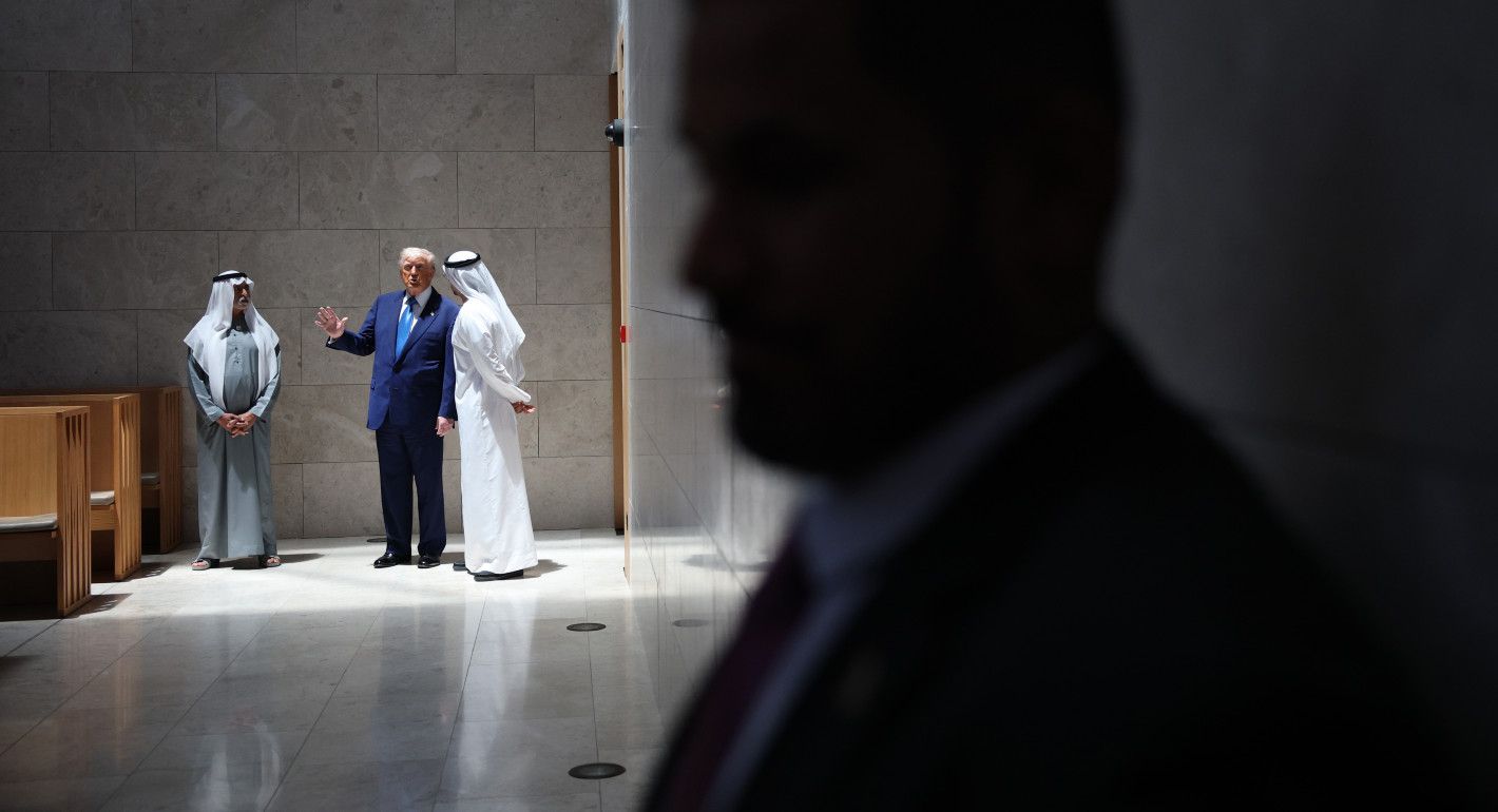 Trump and two UAE officials speaking in the background