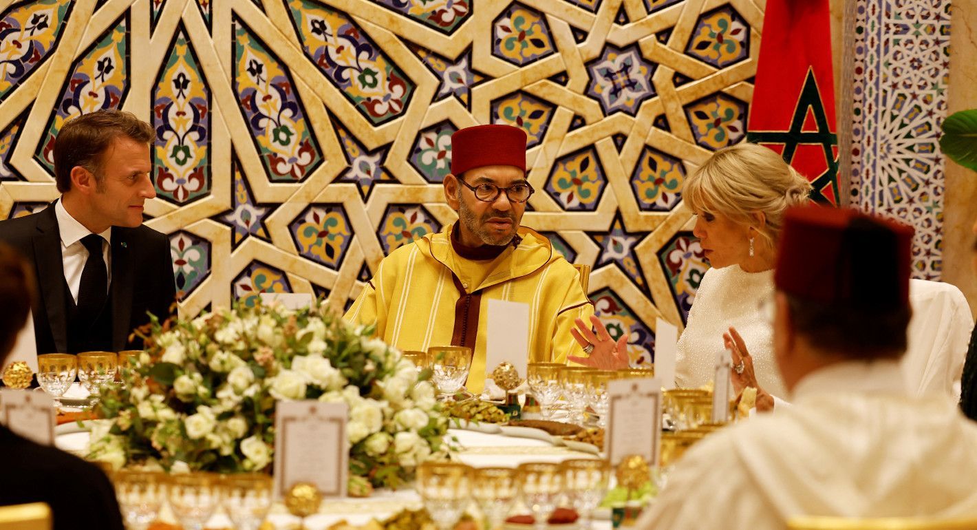 people sitting at a ballroom dinner table talking