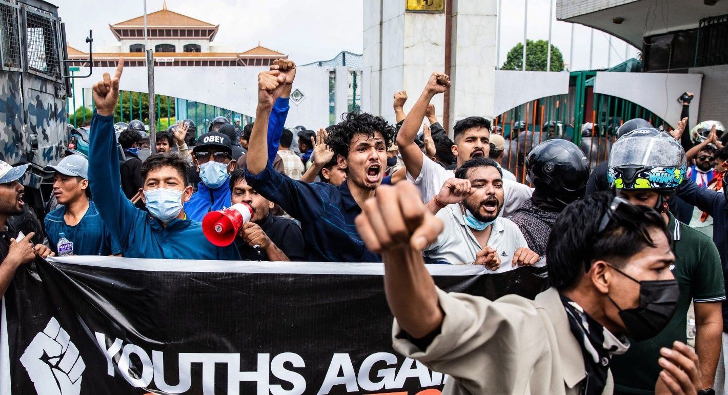 protesters marching and shouting with raised fists