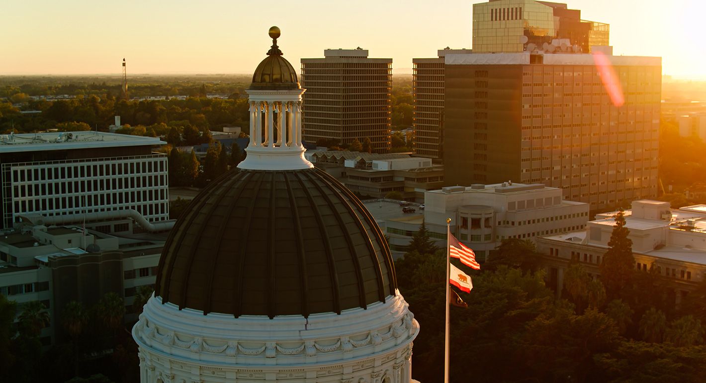 Flags fly over the California state capitol building