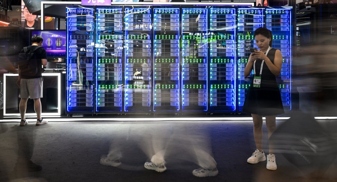 large electronic screen with people walking by