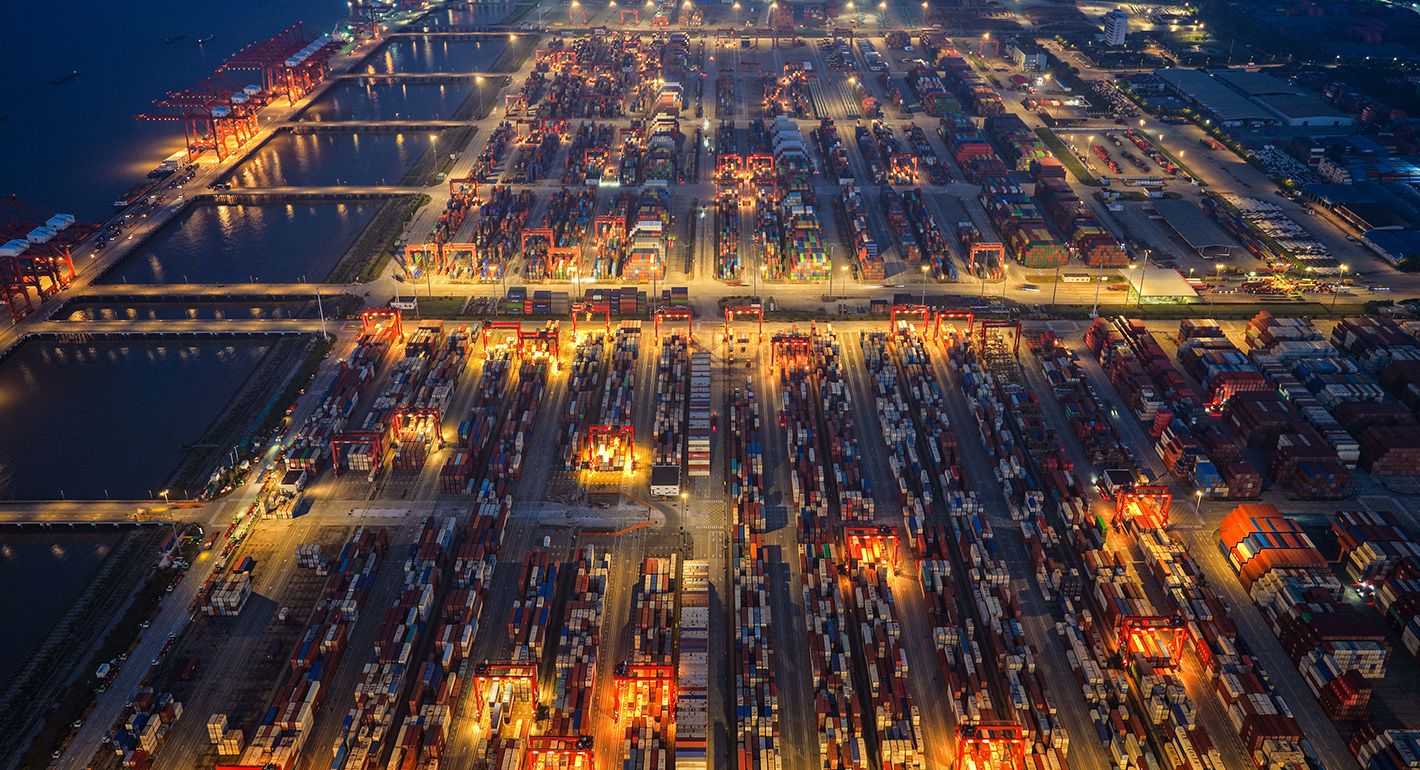 An aerial view shows containers stacked at a port in Taicang, in eastern China's Jiangsu province on May 18, 2025.