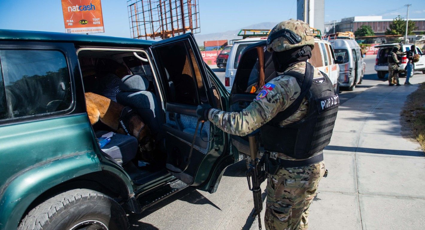 Police officer and canine searching a car
