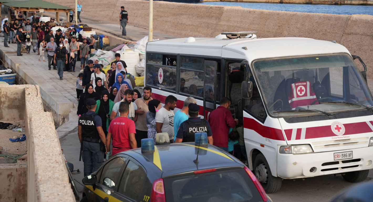 A line of people getting on a bus