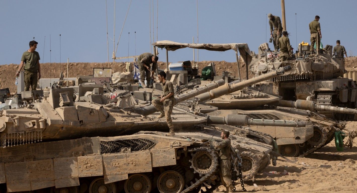 soldiers standing on or near tanks