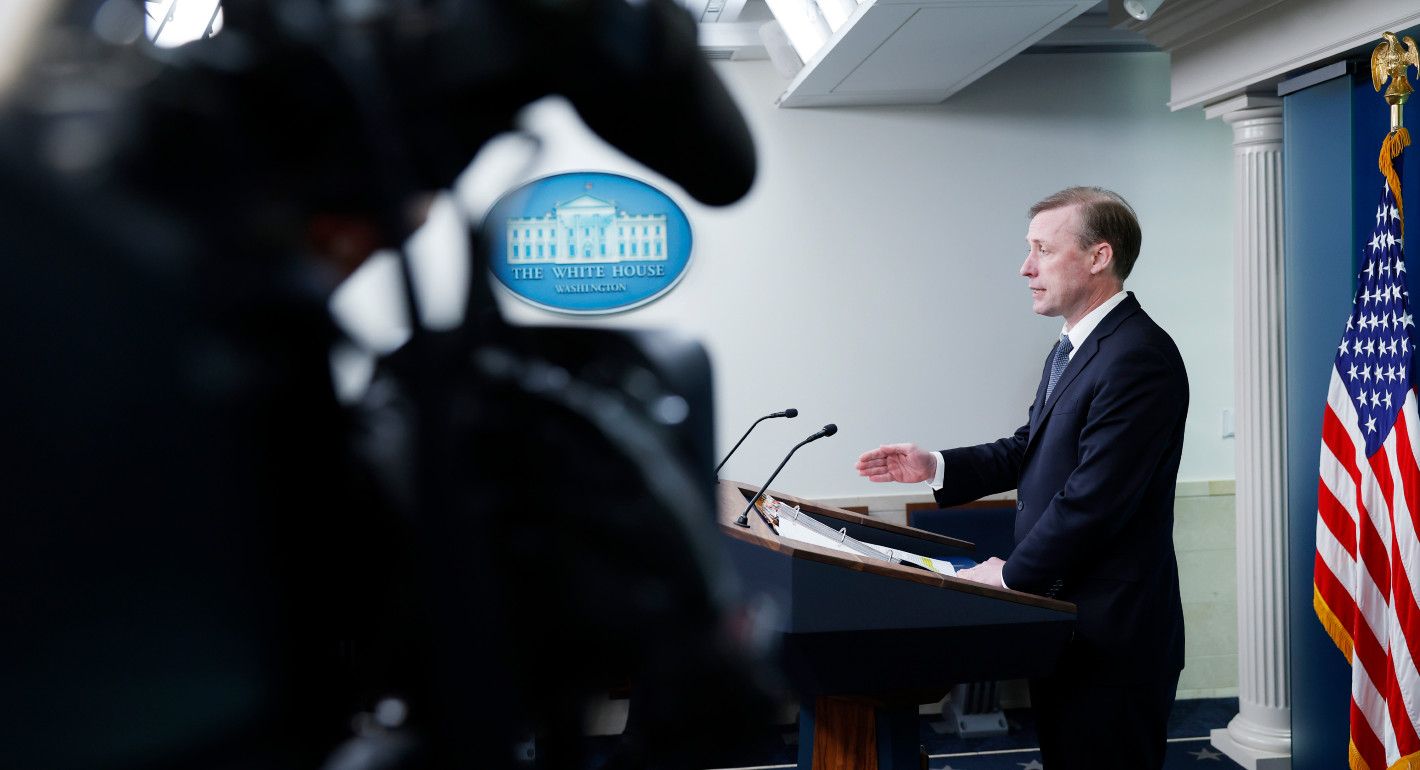 View of Jake Sullivan speaking into a mic, with a camera in the foreground