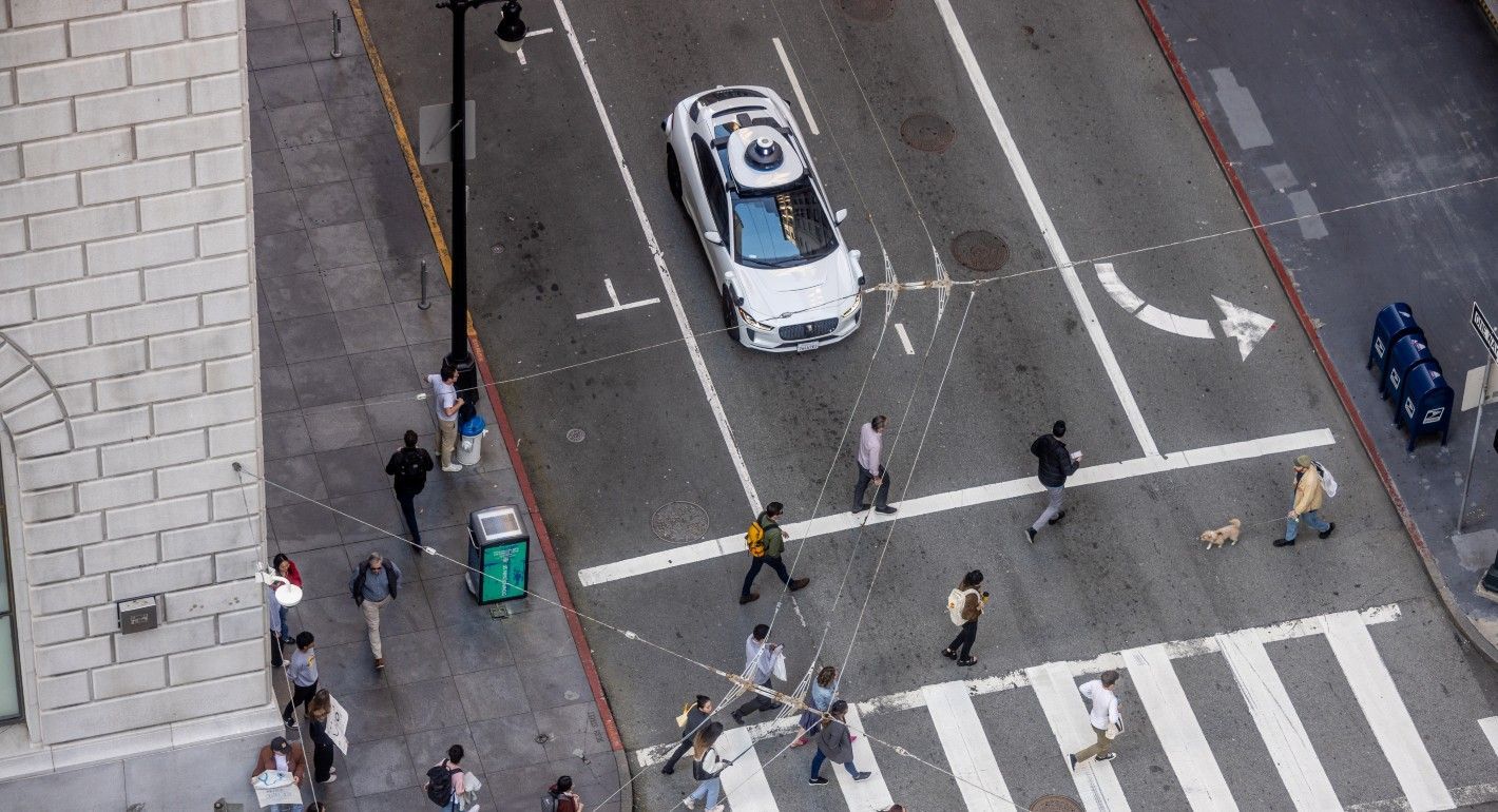 Aerial view of self-driving car approaching crosswalk