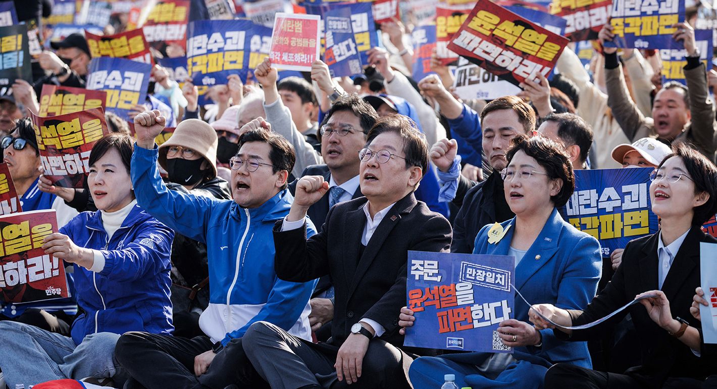 South Korea's main opposition Democratic Party (DP) leader Lee Jae-myung (C) and Park Chan-dae (2nd L), floor leader of DP, attend a demonstration against impeached South Korean President Yoon Suk Yeol in Seoul on March 22, 2025. 