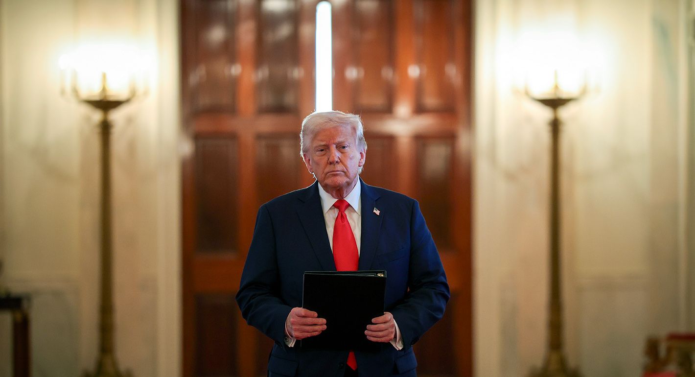 Donald Trump walks down a hallway