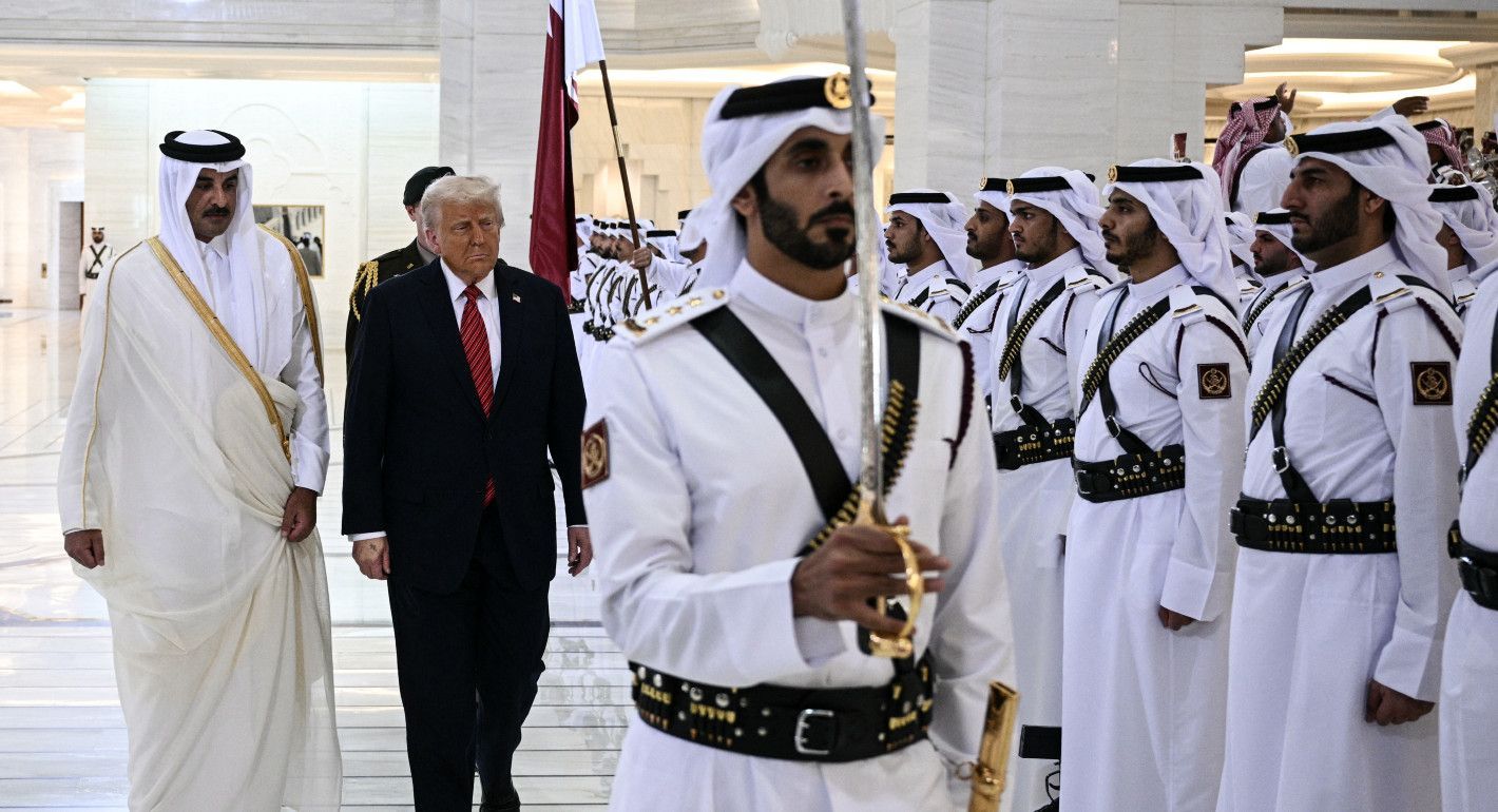 Two leaders looking at a line of men in military uniforms