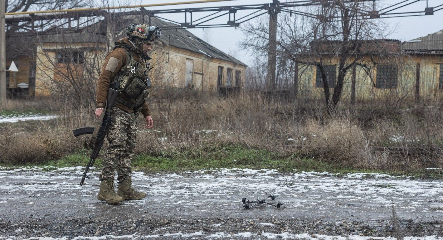 Soldier looking at a drone on the ground